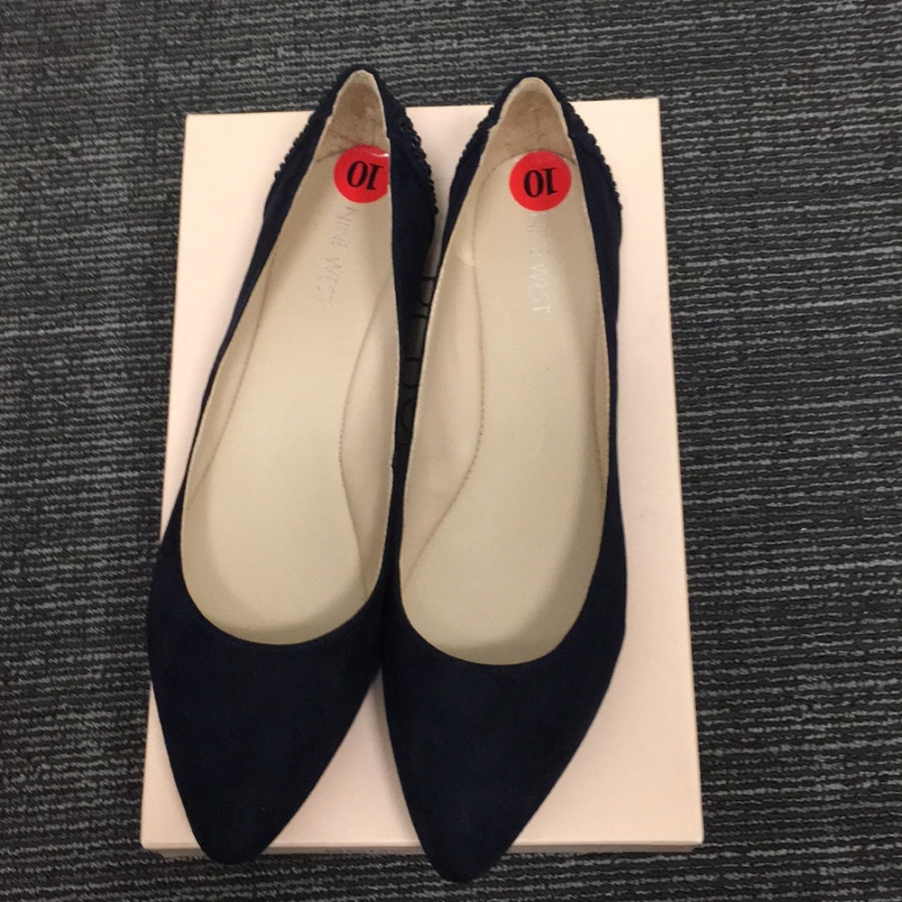 Navy flats with sparkle embellishments at the heel